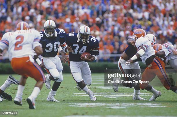 Running back Bo Jackson of the Auburn University Tigers moves the ball with his teammates against the Florida Gators during the 1980's.