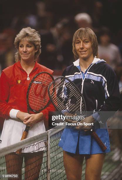 Martina Navratilova poses next to the net with Chris Evert Lloyd before the Virginia Slims Tournament Series during the 1980s.