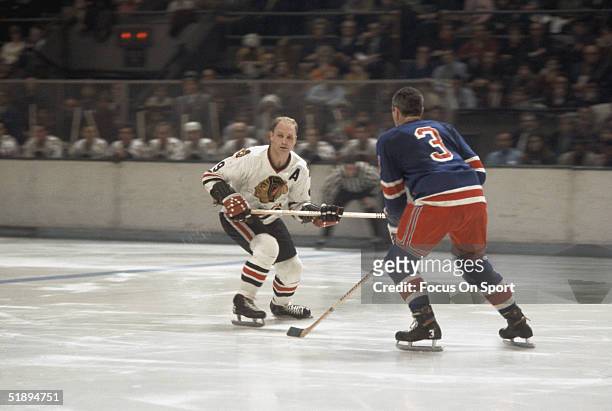 Bobby Hull of the Chicago Blackhawks looks for the pass.