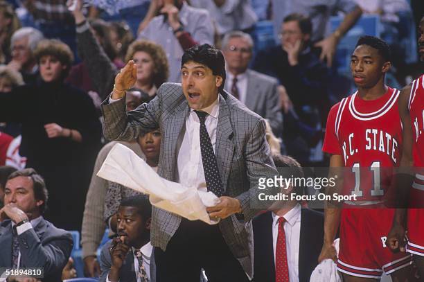 Head coach Jim Valvano of the North Carolina State Wolfpack gestures and yells to his team from the sidelines circa 1989.
