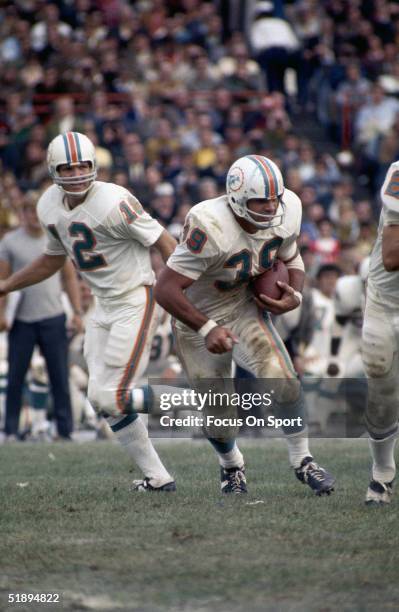 Miami Dolphins fullback Larry Csonka of the Miami Dolphins runs the ball after getting the handoff from quarterback Bob Griese circa 1980's.