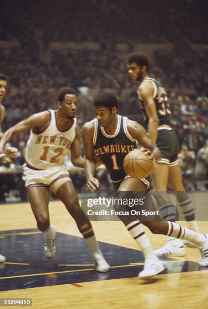 Milwaukee Bucks' Oscar Robertson dribbles against New York Knicks' Dick Barnett during a game at Madison Square Garden in New York, New York.