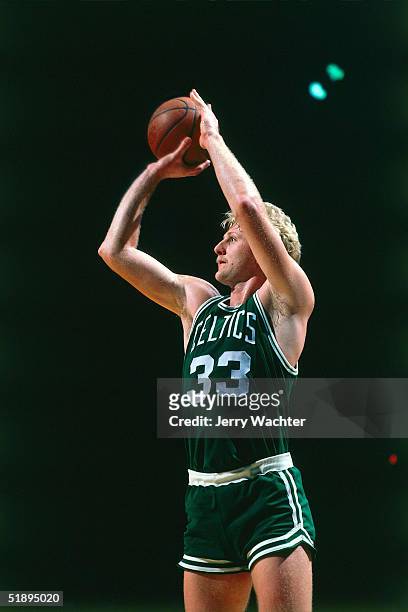 Larry Bird of the Boston Celtics takes a jumper during an NBA game. NOTE TO USER: User expressly acknowledges and agrees that, by downloading and or...