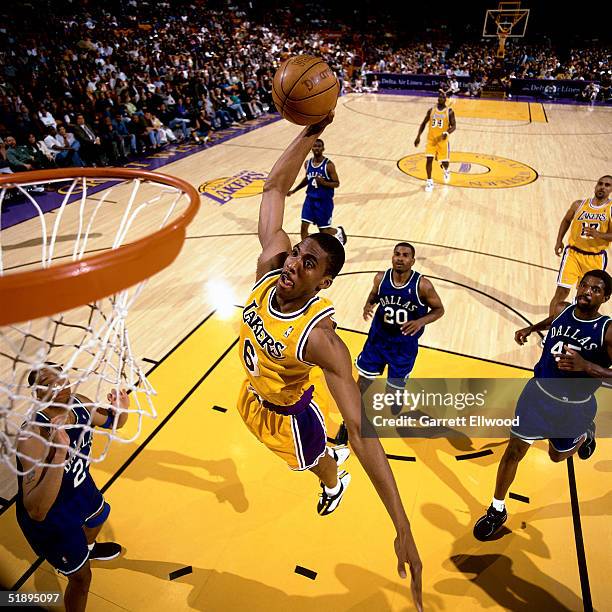 Eddie Jones of the Los Angeles Lakers goes for a dunk against the Dallas Mavericks during the NBA game at the Forum in Los Angeles, California. NOTE...