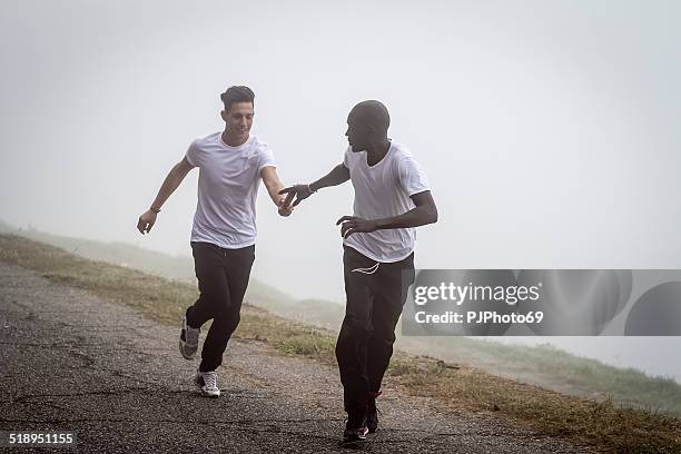 passing the relay baton - stafett bildbanksfoton och bilder