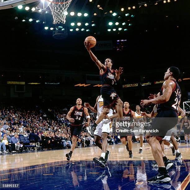 Allen Iverson of the Philadelphia Sixers drives to the basket against the Golden State Warriors during a NBA game at The Arena @ Oakland in 1998 in...