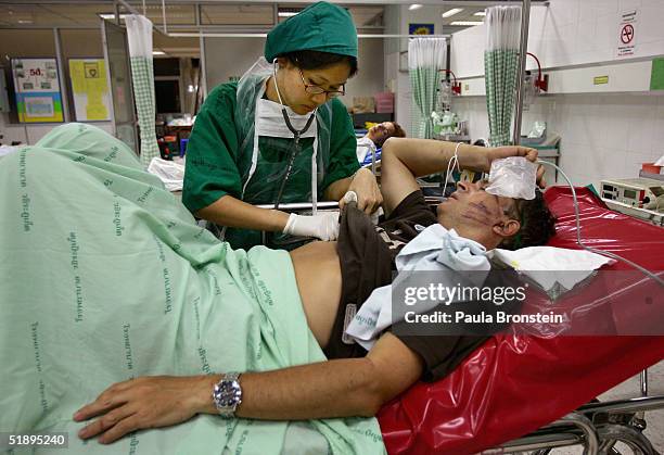 French tourist from the island of Koh Phi Phi receives treatment at Vachira Phuket Hospital on December 27, 2004 in Phuket, Thailand. A huge...