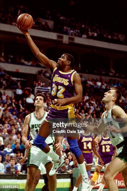 Magic Johnson of the Los Angeles Lakers goes for a layup against the Milwaukee Bucks during the NBA game in Milwaukee, Wisconsin. NOTE TO USER: User...