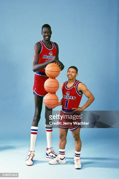 Tyrone "Muggsy"Boges and Manute Bole of the Baltimore Bullets pose for a portrait portraying the tallest and the Shortest in the NBA game in 1987....