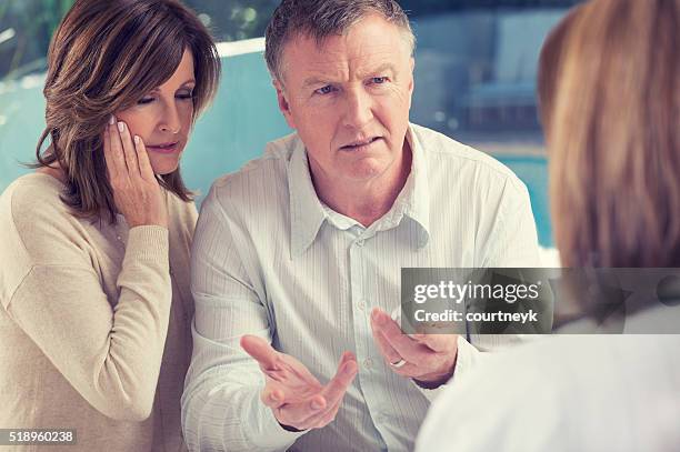 mature couple with doctor and medicine - patient bad news stock pictures, royalty-free photos & images