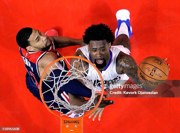 DeAndre Jordan of the Los Angeles Clippers shoots over Garrett Temple of the Washington Wizards during the first half of the basketball game at...