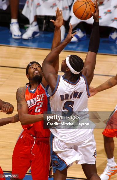 Kwame Brown of the Washington Wizards attempts a shot against Melvin Ely of the Charlotte Bobcats December 27, 2004 at the MCI Center in Washington,...