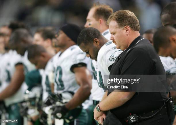 Philadelphia Eagles coach Andy Reid observes a moment of silence for former Eagles and Green Bay Packers star Reggie White, who passes away December...
