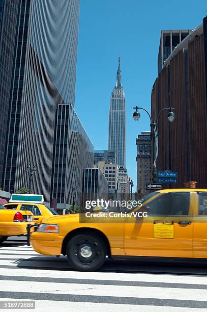 yellow taxis crossing intersection with empire state building in the distance, new york city, new york, usa - taking a vintage ny taxi cab stock pictures, royalty-free photos & images