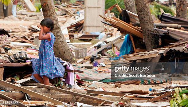 Young girl cries as she walks through the debris after the massive tsunami wave swept across coastal Sri Lanka, December 28, 2004 in Colombo, Sri...