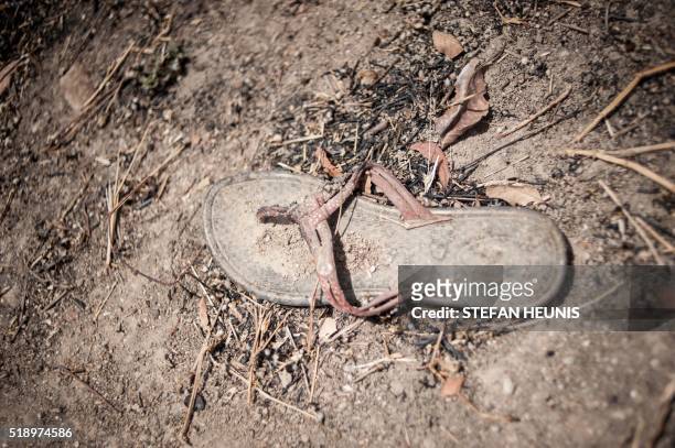 Photo taken on March 25, 2016 shows a slipper lying amongst the rubble of the demolished dormitories of the Government Girls Secondary School Chibok...