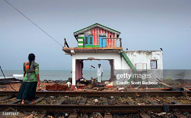Husband and wife inspect the remains of their home on the coast of the Ratmalana district after the massive tsunami wave swept across coastal Sri...