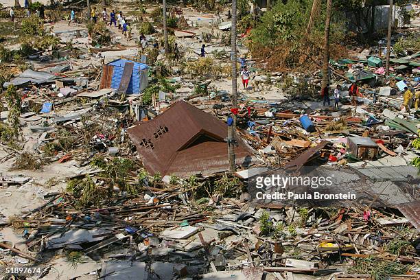 Rescue workers comb through the devastation December 28, 2004 in Phi Phi Village, Ton Sai Bay, Thailand. Hundreds were killed on the island when an...