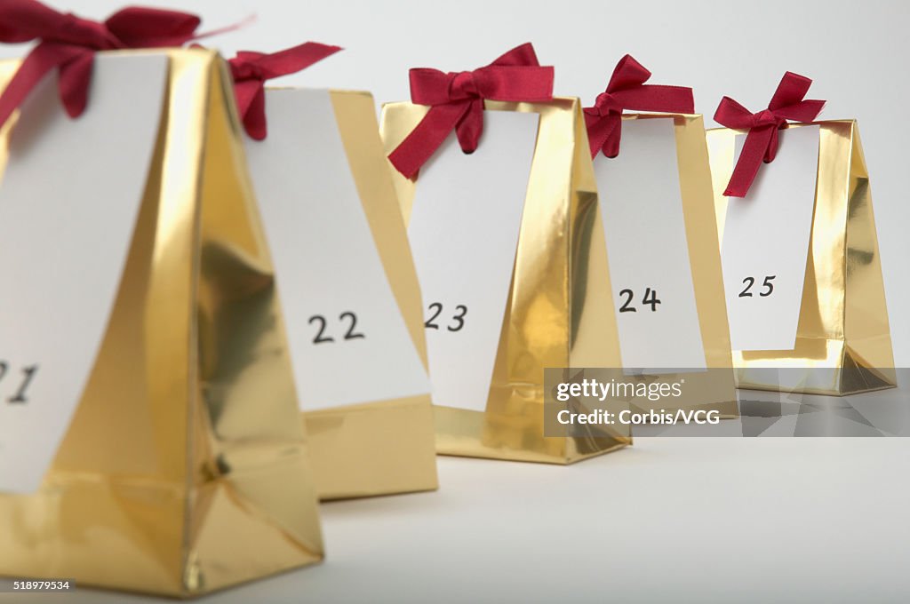 Detail view of a row of Christmas presents labeled with the numbers 21 to 25