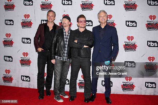 Musician The Edge and singer Bono of U2, winners of the Innovator Award, pose with Tom Poleman , iHeart Media President of National Programming...