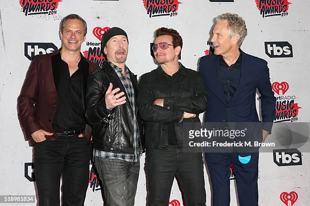 Musician The Edge and singer Bono of U2, winners of the Innovator Award, pose with Tom Poleman , iHeart Media President of National Programming...