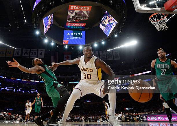 Julius Randle of the Los Angeles Lakers and Jae Crowder of the Boston Celtics battle for the basketball during the first half of the basketball game...