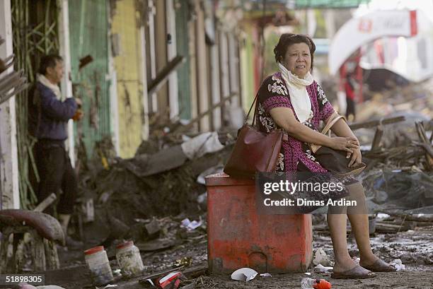 An Aceh resident sits in a street after a Tsunami hit the ,150 miles from southern Asia's massive earthquake's epicenter, on December 28, 2004 in...