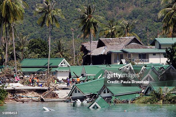 An ocean front hotel is seen collapsed into the sea close to the pier on December 28, 2004 on Kho Phi Phi, Thailand. The Taunamis that ripped through...