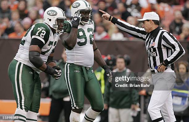 Defensive tackle Jason Ferguson and defensive end Shaun Ellis of the New York Jets react to referee Tony Corrente while facing the Cleveland Browns...