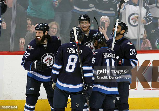 Chris Thorburn, Jacob Trouba, Adam Lowry, Matt Halischuk and Dustin Byfuglien of the Winnipeg Jets celebrate a second period goal against the...