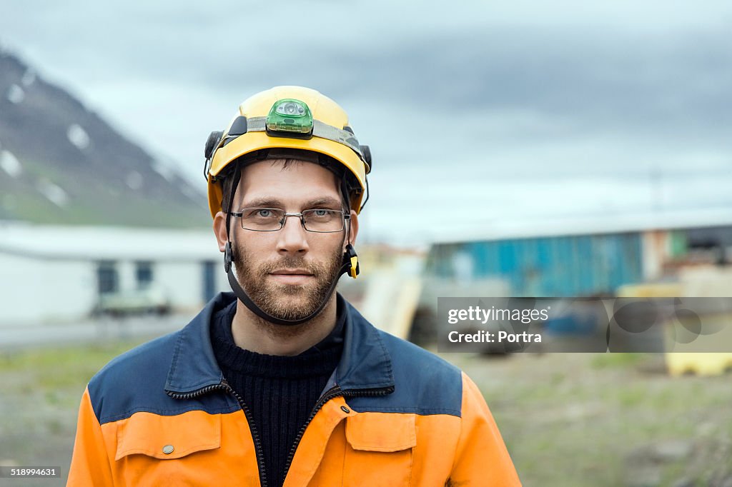 Confident construction worker at wearing hardhat