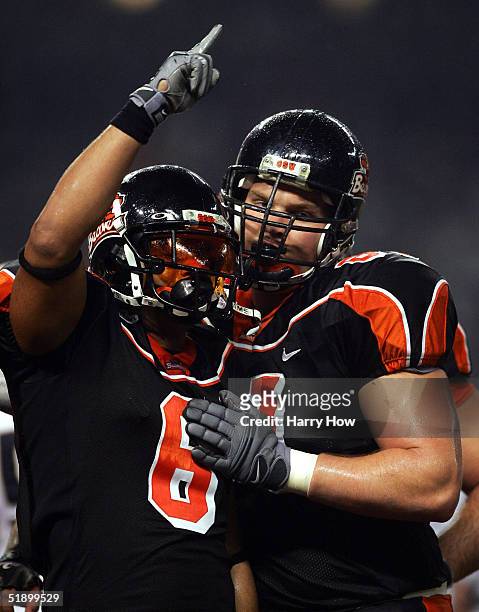 George Gillett of Oregon State celebrates his touchdown with Adam Koets against Notre Dame in the first quarter of the Insight Bowl at Bank One...