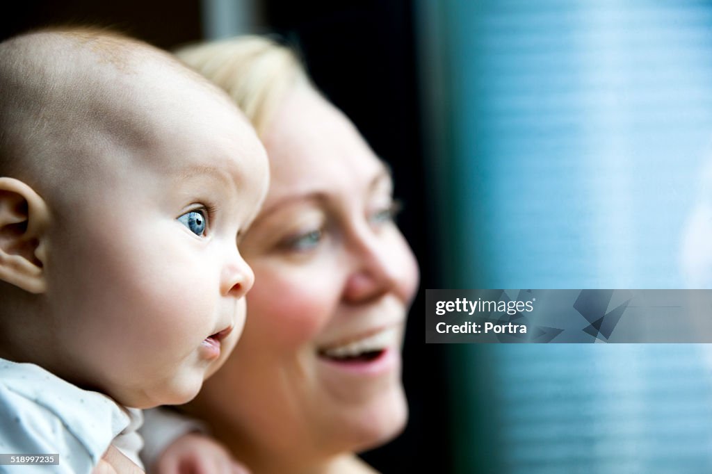 Curious baby with happy mother