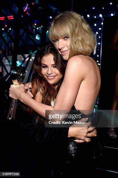 Singer Taylor Swift , winner of the Album of the Year award for '1989,' embraces actress/singer Selena Gomez backstage at the iHeartRadio Music...