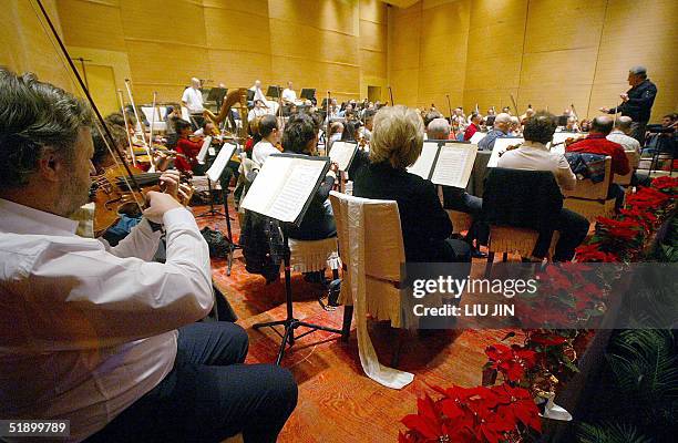 Indian conductor Zubin Mehta and the Israel Philharmonic Orchestra process a rehearsal of New Year's Concert in Shanghai, 29 December 2004. Zubin...