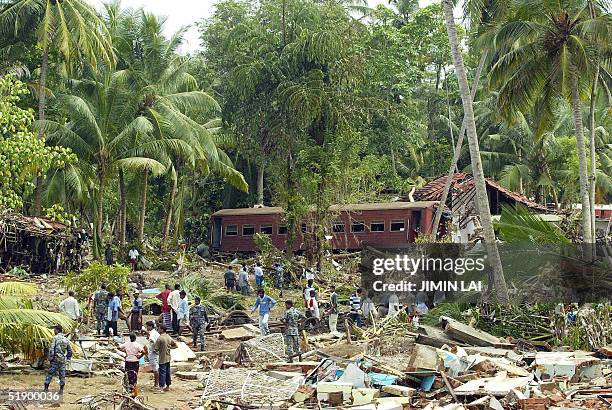 General view of the wreckage of houses and train carriages after tidal waves washed away the train in Sinigame near the tourist town of Hikaduwa on...