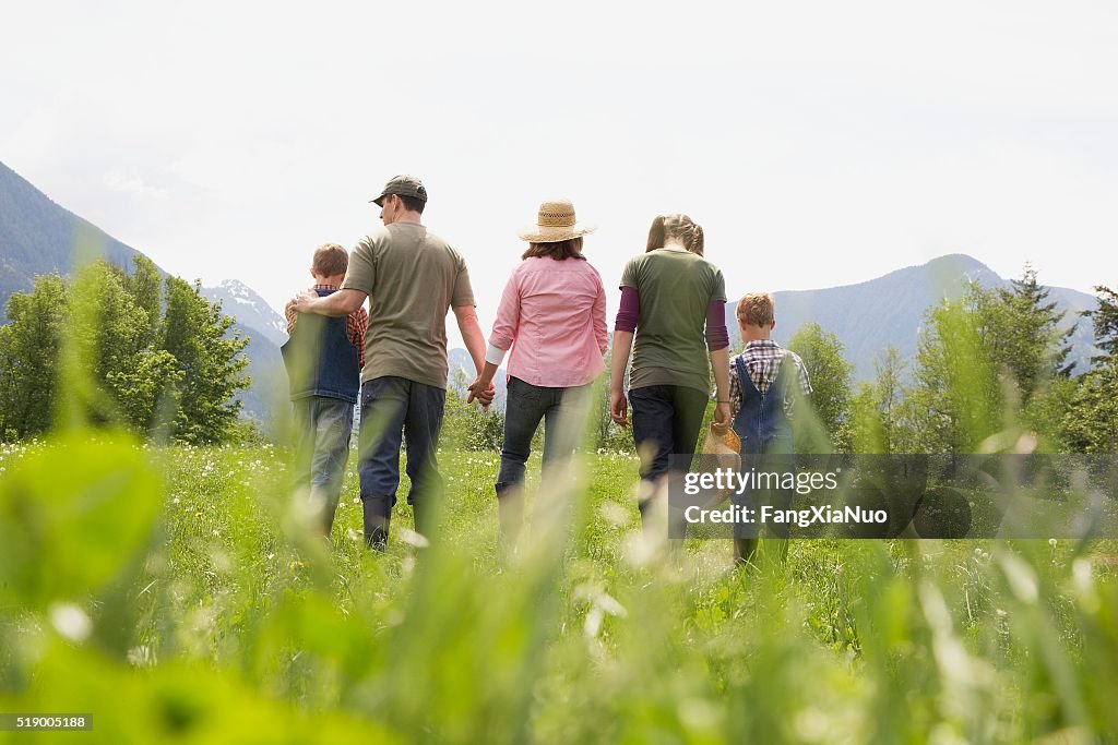 Family walking in field