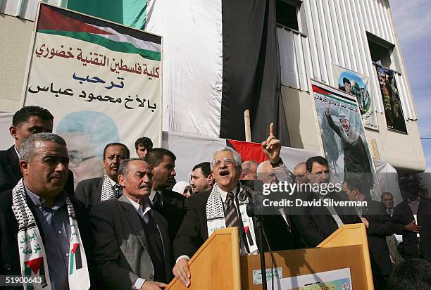Interim Palestinian leader Mahmoud Abbas addresses supporters from below a Yasser Arafat poster as he campaigns for the upcoming January 9...