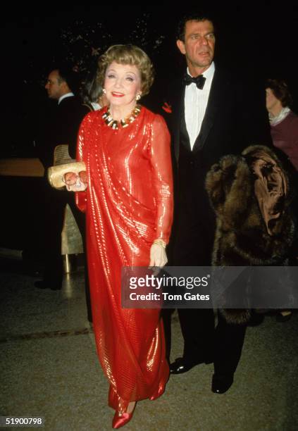 French-born actress Claudette Colbert and companion Peter Rogers attend the opening night of the Costume Institute of Metropolitan Museum of Art and...