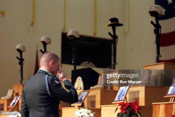 1st Sgt. Carlon Addison salutes at a memorial service for six members of the 1st Brigade, 25th Infantry Division December 29, 2004 in Fort Lewis,...