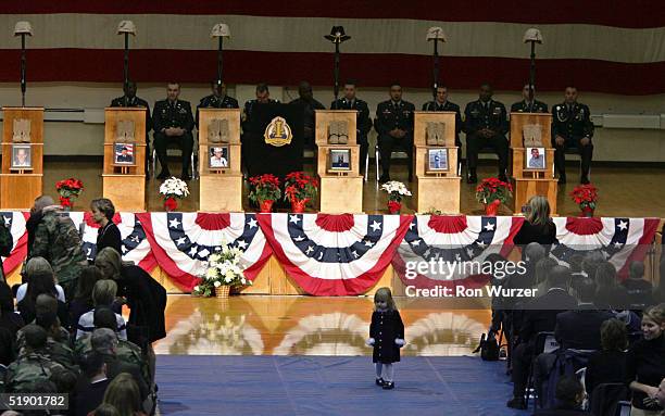 Avalon Jacobsen wanders from her mother during a memorial service for her father, Capt. William W. Jacobsen Jr., and five other soldiers, members of...
