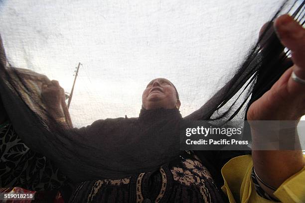 Kashmiri Muslim woman prays as a head priest displays the relic, believed to be the hair from the beard of the Prophet Mohammad , during special...