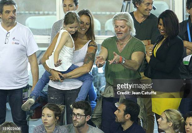 Laure Manaudou, holding her daughter Manon Bousquet meets her former coach Philippe Lucas on day 6 of the French National Swimming Championships at...