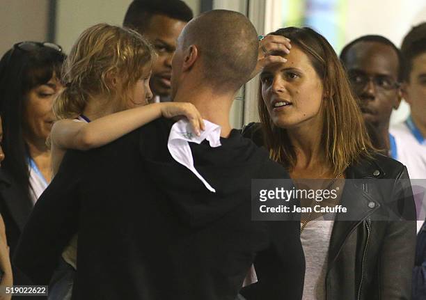 Laure Manaudou greets her former boyfriend Frederick Bousquet, holding their daughter Manon Bousquet, after his 50m freestyle final during day 6 of...