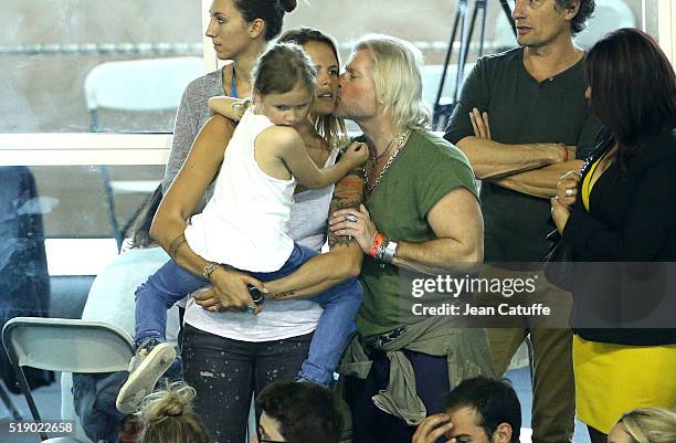 Laure Manaudou, holding her daughter Manon Bousquet meets her former coach Philippe Lucas on day 6 of the French National Swimming Championships at...