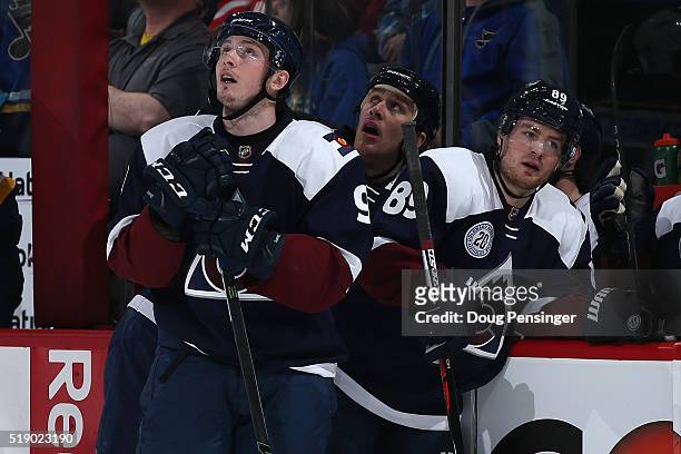 Matt Duchene, Shawn Matthias and Mikkel Boedker of the Colorado Avalanche look on as the St. Louis Blues celebrate a goal by Colton Parayko of the...