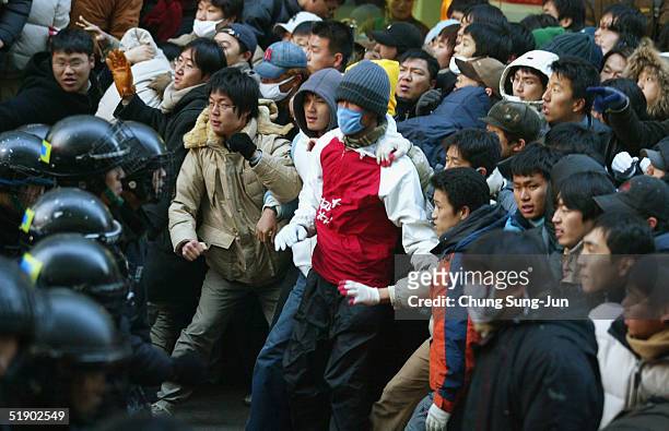South Korean protesters scuffle with riot police as they march to National Assembly during a rally demanding repeal National Security Law in front of...