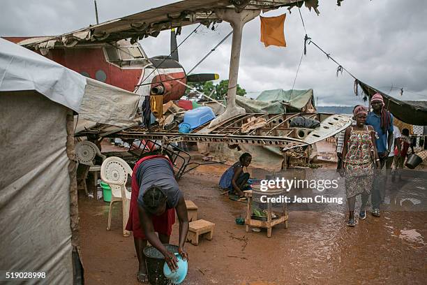 Women Children tend food stalls around a disposed airplane inside M'poko IDP camp near Bangui Airport on November 6, 2015 in Bangui, Central African...