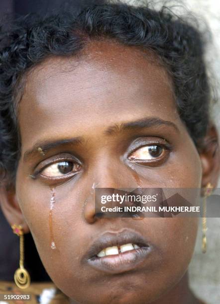 Homeless Sri Lankan woman Sukhriti cries as she mourns the loss of her eight month old son washed away by the 26 December giant tsunami waves which...