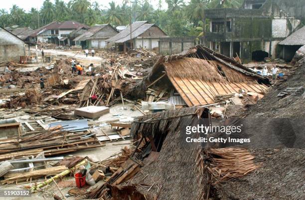Houses lie destroyed at Sirombu village December 29, 2004 in Nias, North Sumatra, Indonesia. Tens of thousands of people have been killed in...